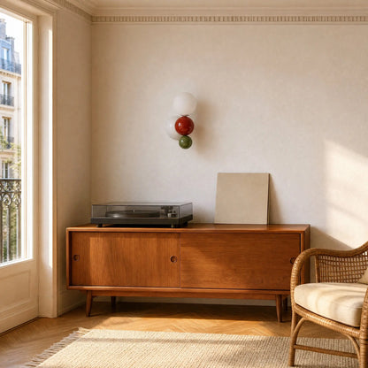 Applique murale boule rouge et verte au-dessus d'un meuble en teck et d'une platine vinyle