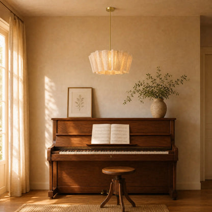 Suspension Rinaya sur tige dorée Ø 50 cm allumée au-dessus d'un piano droit